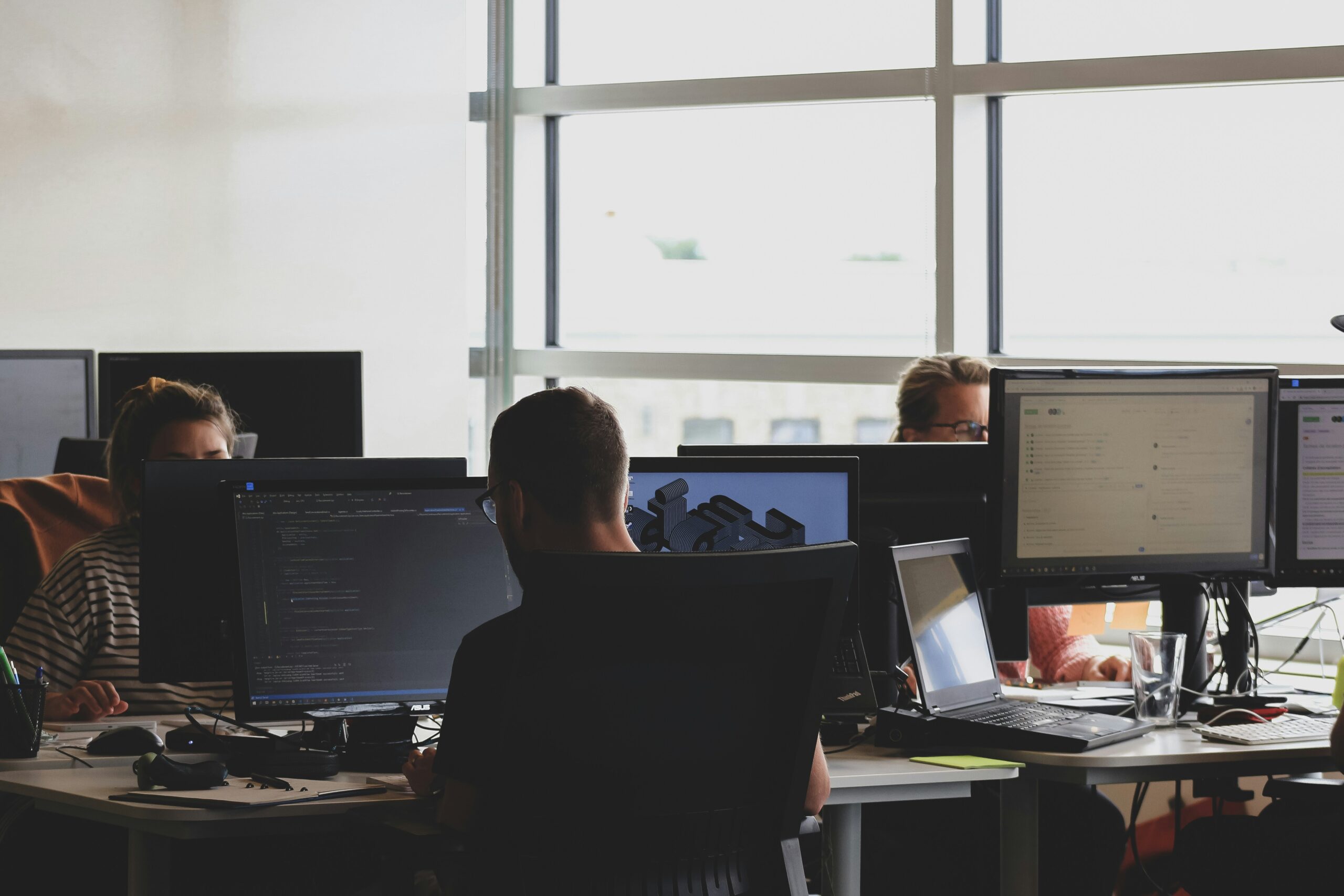 people sitting on chair people sitting on chair in front of computer monitor